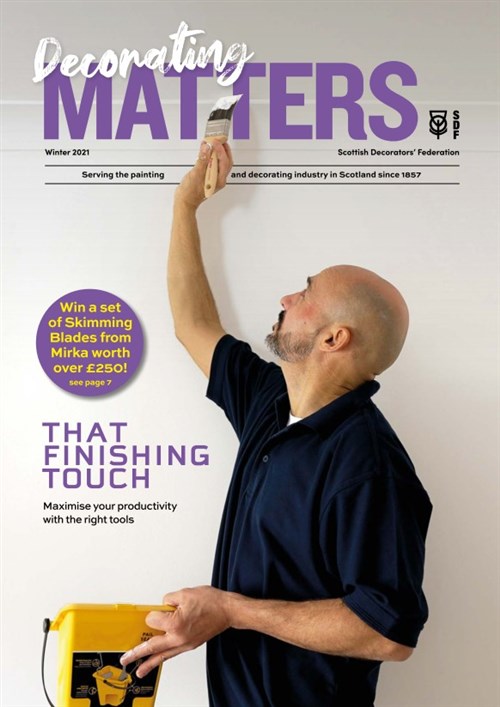 Cover, Decorating matters Winter 2021. A painter cuts in on the edge of a ceiling